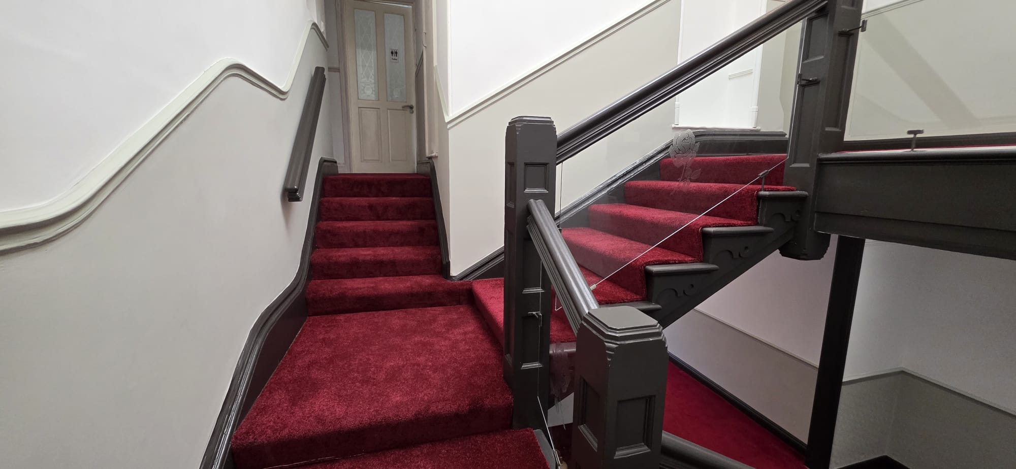 Completed staircase renovation with new red carpeting at Shanthi Vihara